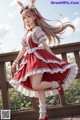 A woman in a red and white dress with a bunny ears headband.